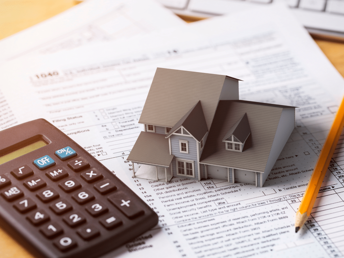 A mortgage professional reviewing loan documents with homeowners in a Tallahassee home.